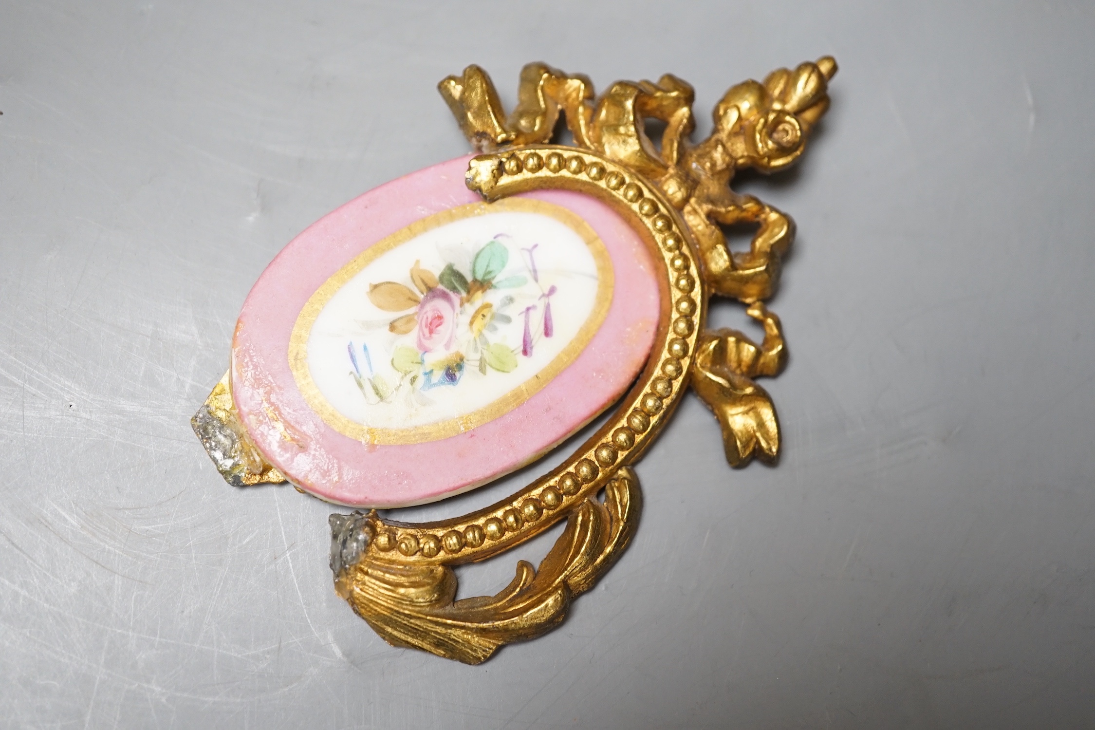 A French gilt metal and porcelain clock garniture. 36.5cm